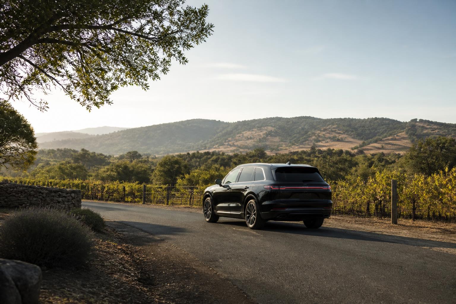 Black luxury SUV on a quiet wine country road